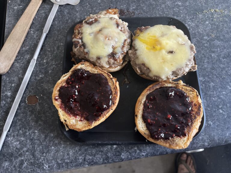 Burger with egg in the middle, monterey jack, and blackberry sauce